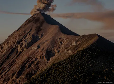 Fuego volcano erupting at night seen from the private 4x4 tour camp