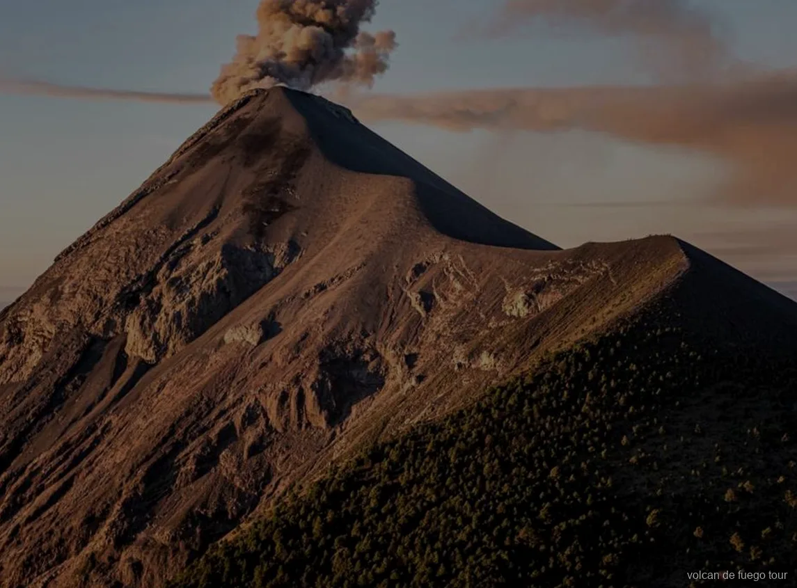 Fuego volcano erupting at night seen from the private 4x4 tour camp